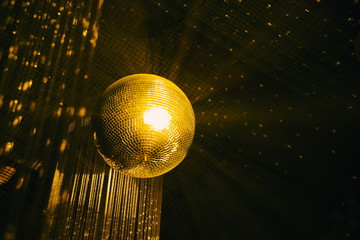 golden disco ball on black background