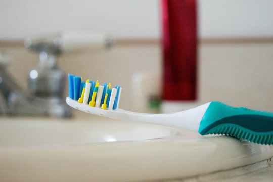 Close-Up Of Toothbrush On Bathroom Sink