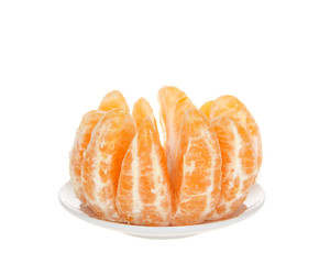Whole sumo orange peeled and separated sitting on small round plate isolated. Native to Japan, Sumo oranges are a hybrid citrus fruit that's a cross between mandarin and a California naval orange