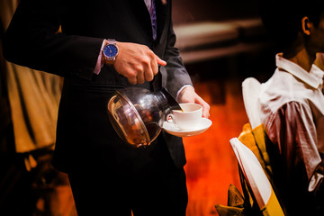 Make a coffee by hand and a white cup in a row.