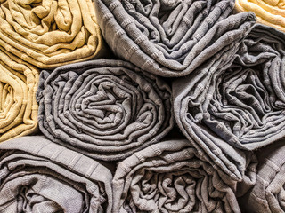 Sheets of cloth or towels rolled and stacked on each other, clean and ready to be used for hygiene purposes and for body care