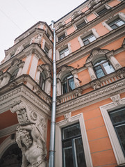 Snow-covered St. Petersburg street, historical beautiful facades of buildings with statues