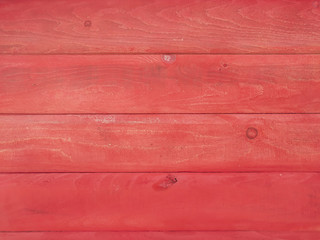 Modern red colored wooden wall block made of wood planks of natural material making a cool wallpaper background in red color