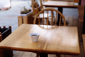 Cup of coffee on a wooden table.