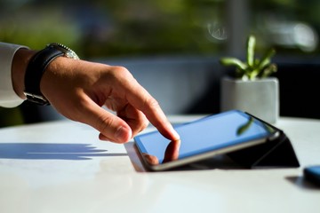 Man hand clicks on digital tablet, closeup