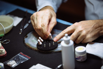 Dental technician makes dentures.