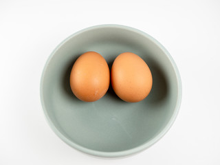 Put eggs in one bowl on white background
