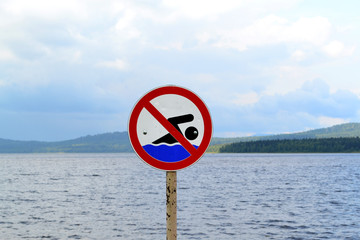 No swimming sign set on the lakefront