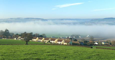 Fototapeta na wymiar Village of Musbury in Axe Valley, Devon on the misty morning
