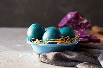 Blue marble Easter eggs painted by natural dyes. Purple cabbage is natural paint. Copy space
