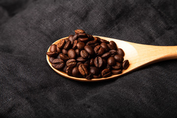 Composition with a coffee beans on a linen napkin for background