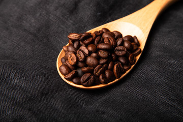 Composition with a coffee beans on a linen napkin for background