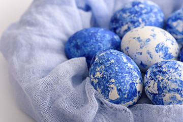 close-up of Easter eggs in the color of the year-classic blue with gradient effect in blue cloth towel