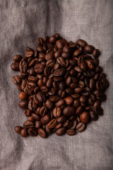 Composition with a coffee beans on a linen napkin for background