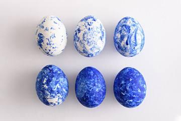 six Easter eggs in the color of the year-classic blue with gradient effect in two rows on white background