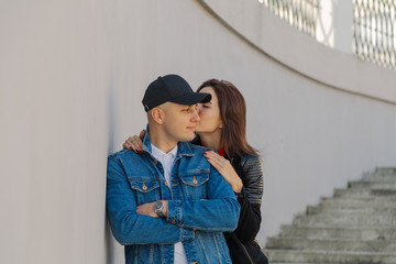 Fototapeta premium Happy lovers hug on a concrete staircase.