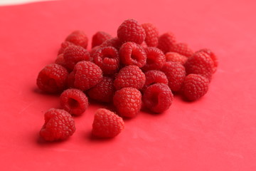 delicious raspberries in colorful background