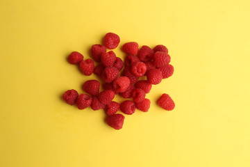 delicious raspberries in colorful background