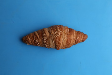 delicious spelled croissant in color background
