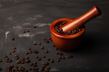 Composition with a coffee beans on a textured plastered background with a variety of arbitrary stains