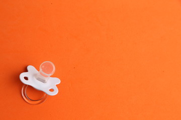 white pacifier in color background