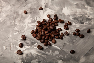 Composition with a coffee beans on a textured plastered background with a variety of arbitrary stains