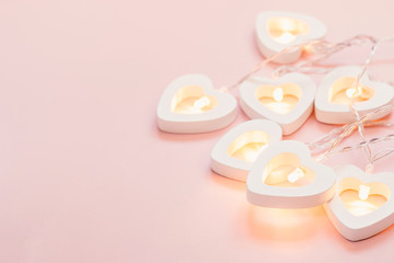 Valentine's Day Card. Delicate pink background with heart garland. Valentine's day or wedding party decor