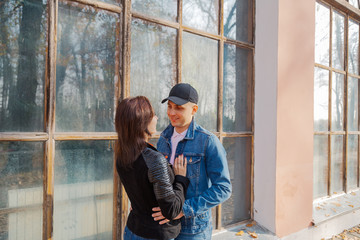 Happy lovers by the window in the park in autumn weather.