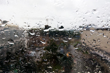 abstract full frame background showing a window with raindrops rolling off.
