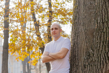 Man on a background of yellow leaves in autumn.