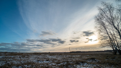 Beautiful setting sun over frozen field