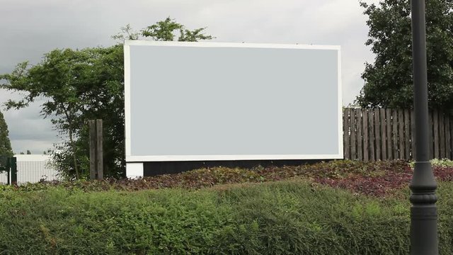Blank Billboard for advertising display sign.  Traffic drives past.