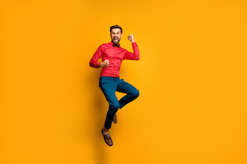 Fototapeta na wymiar Yeah. Full body photo of funny crazy guy jump high up celebrating lottery money winning wear trendy red shirt bow tie trousers shoes outfit isolated yellow color background