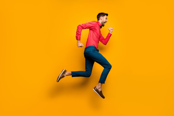 Full length profile photo of crazy funny guy jumping high up rushing black friday shopping wear trendy red shirt bow tie pants shoes outfit isolated yellow color background