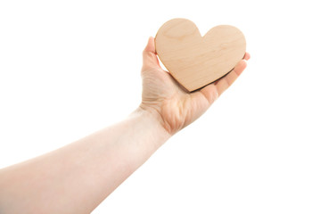 The wooden heart in the woman's hand agains white sky