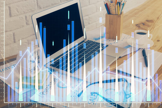 Financial graph colorful drawing and table with computer on background. Multi exposure. Concept of international markets.