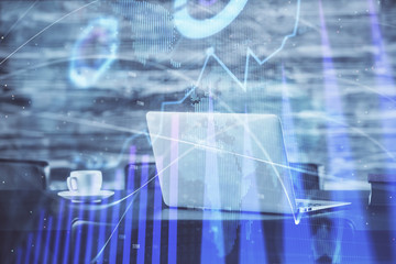 Stock market graph and table with computer background. Double exposure. Concept of financial analysis.