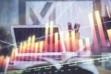 Stock market graph on background with desk and personal computer. Double exposure. Concept of financial analysis.