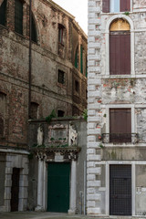 Walls and windows of old buildings in street of Venice 