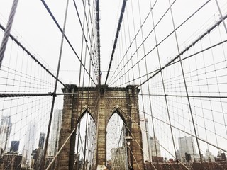Low Angle View Of Suspension Bridge In City