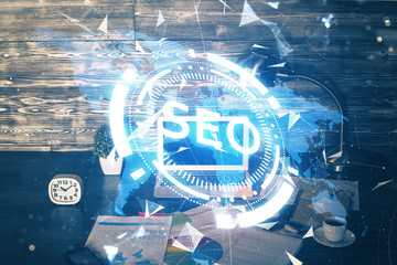 Multi exposure of table with computer and seo drawing hologram. Search optimization concept.