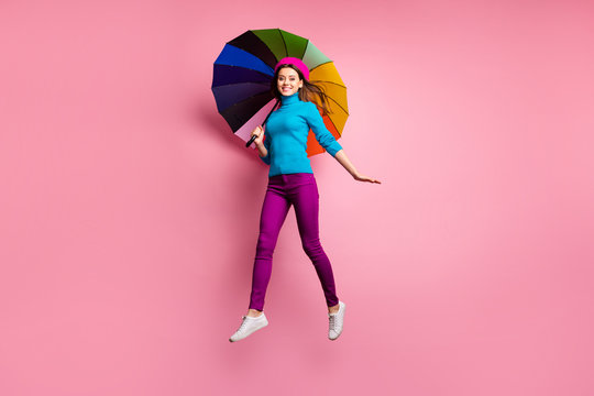 Full size photo of sweet cute lady have fall weekend rest enjoy jump rain weather hold bright parasol wear good looking clothes isolated over pink color background
