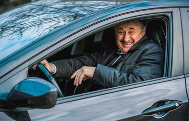 Drunk and crazy senior in automobile. Mature older man lifestyle