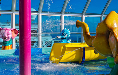 Aqua Park or childrens pool and play area on outdoor deck of modern cruiseship or cruise ship liner