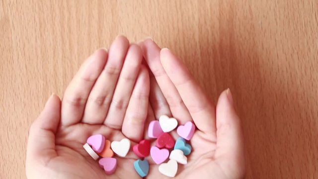Hand holding tiny heart.