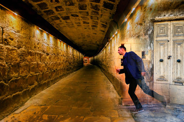 A man running out of a door into a tunnel, reincarnation