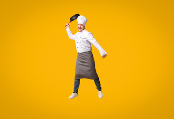 Fototapeta na wymiar Funny Chef Man Jumping Raising Frying Pan, Yellow Background