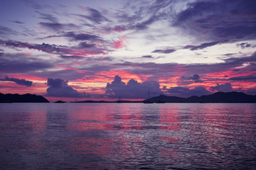 Naklejka na ściany i meble Beautiful colorful sunset on ocean beach. Sky is reflecting at water.