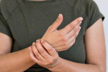 A woman massaging and stretching her hands