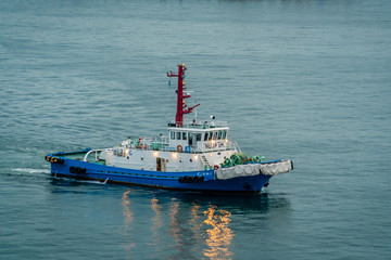 Kanazawa, Japan - 29 Sep 2019 : A Tug boat is leading the way for a large cruise ship